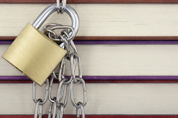 Stack of books with a chain and padlock