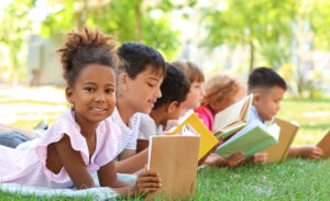 Children avoiding the summer slide by reading books