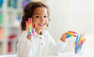Young student engaging in art appreciation through fingerpainting