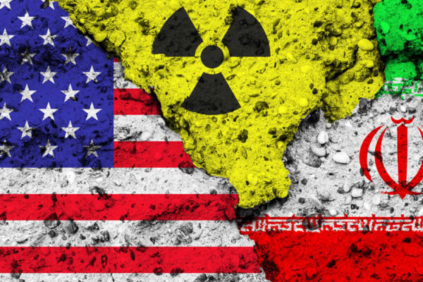 U.S. and Iranian flag fragments with a nuclear symbol between them, representing the Iran Nuclear Program