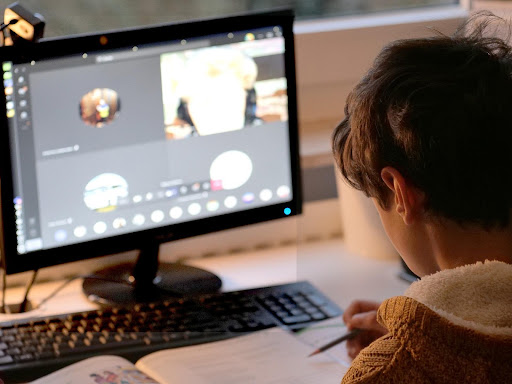 Student using multimedia content on his desktop computer