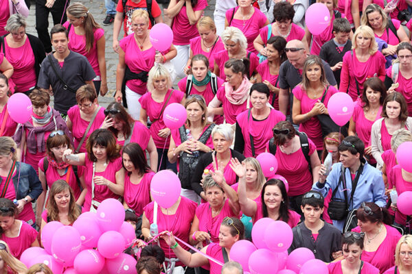A large group of people dressed in pink for Breast Cancer Awareness
