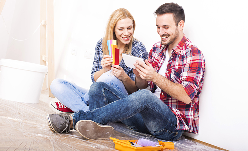 Young couple watching a DIY video while planning a project