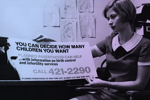 woman holding a Planned Parenthood advertisement