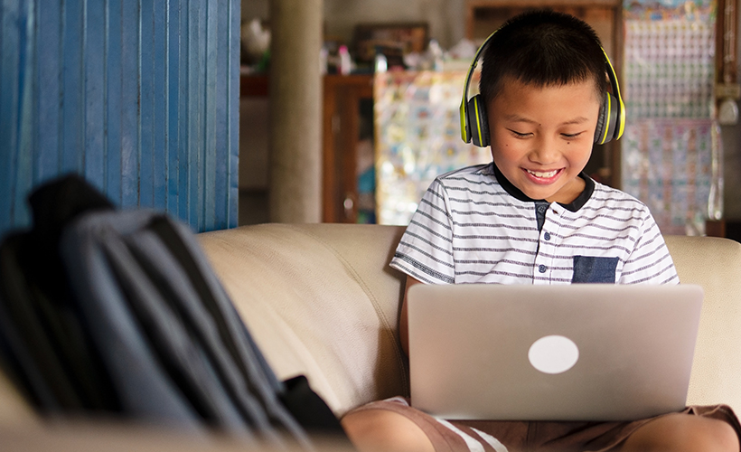 Young student happily participating in a virtual classroom