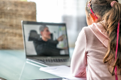 Young student at laptop, taking a virtual class