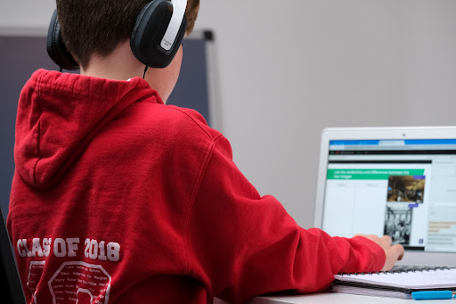 Young student at laptop, doing an assignment