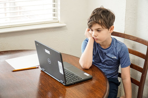 Student looking at laptop for virtual class