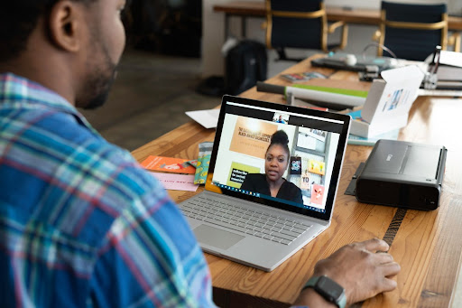 Older student talking with educator in a virtual classroom