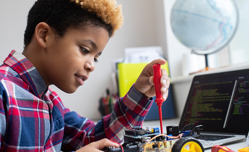 Young student building an object for science class