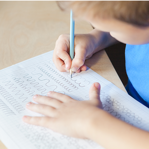 Child writing on paper