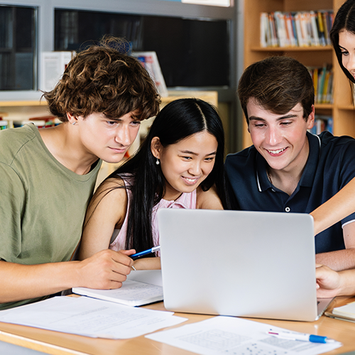 High school students gathered around a laptop