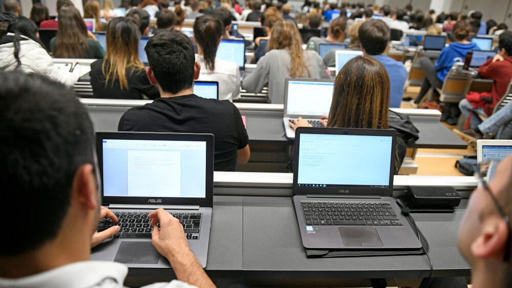 Students in lecture hall with laptops