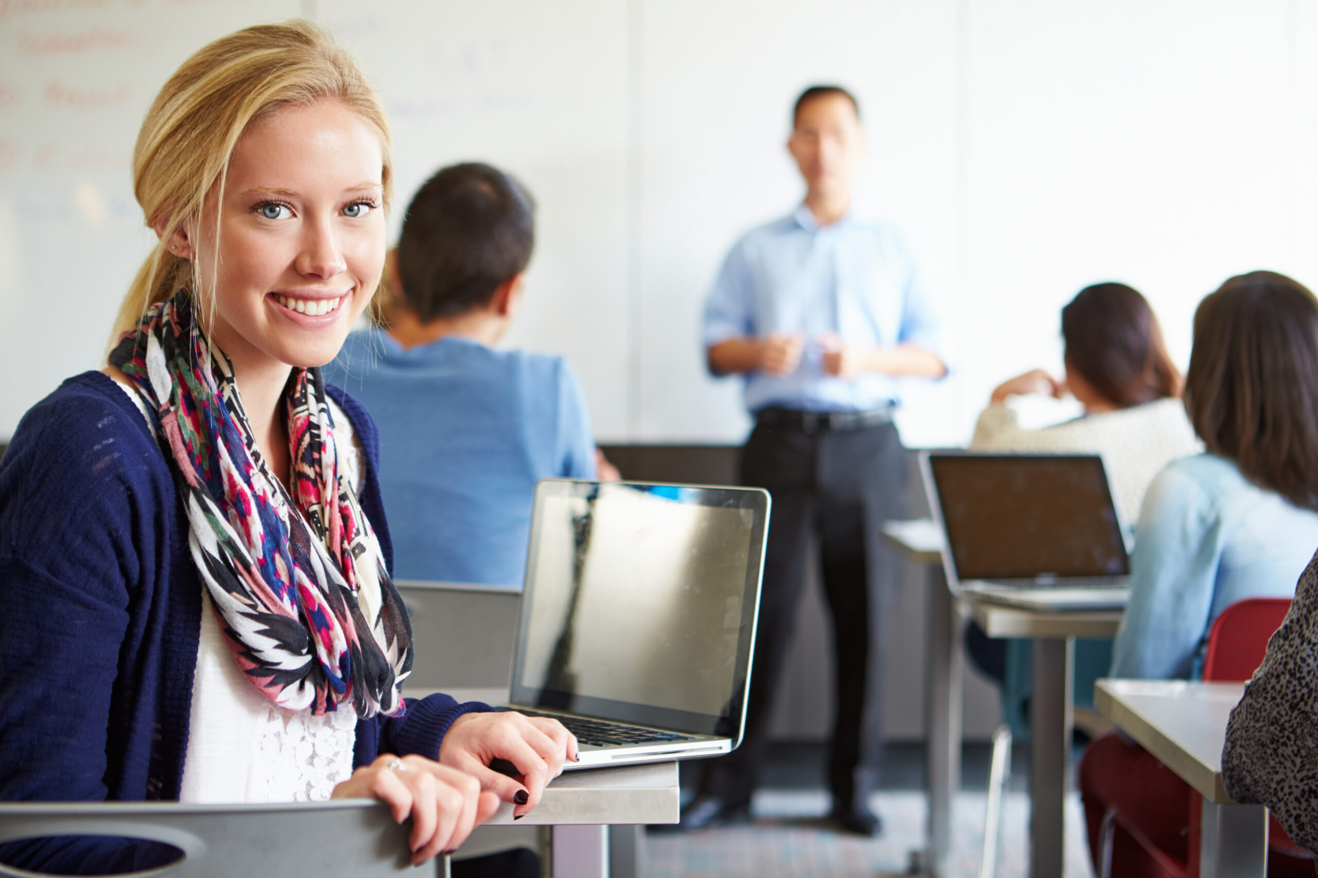 happy student in a classroom, participating in student-centered learning