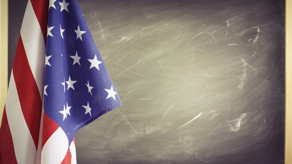 American flag in front of a chalkboard