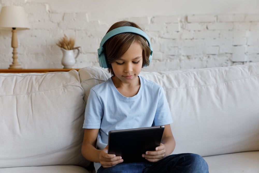 Young learner reading on an iPad.